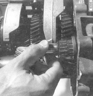 Fig. 7-7. Reverse gear shaft being withdrawn from transmission case.

Manual Transmission and Clutch
page 23